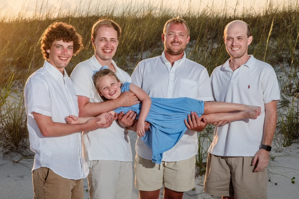 [BAT HITS BALL] Young family having fun on the beach in Orange Beach, Alabama during the photo session.