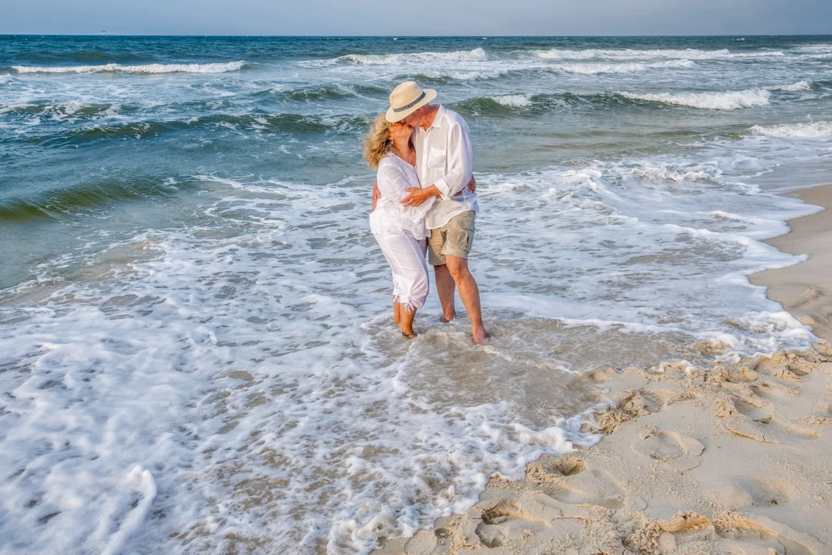 Older couple during a photo session in Orange Beach, Alabama standing in the water.